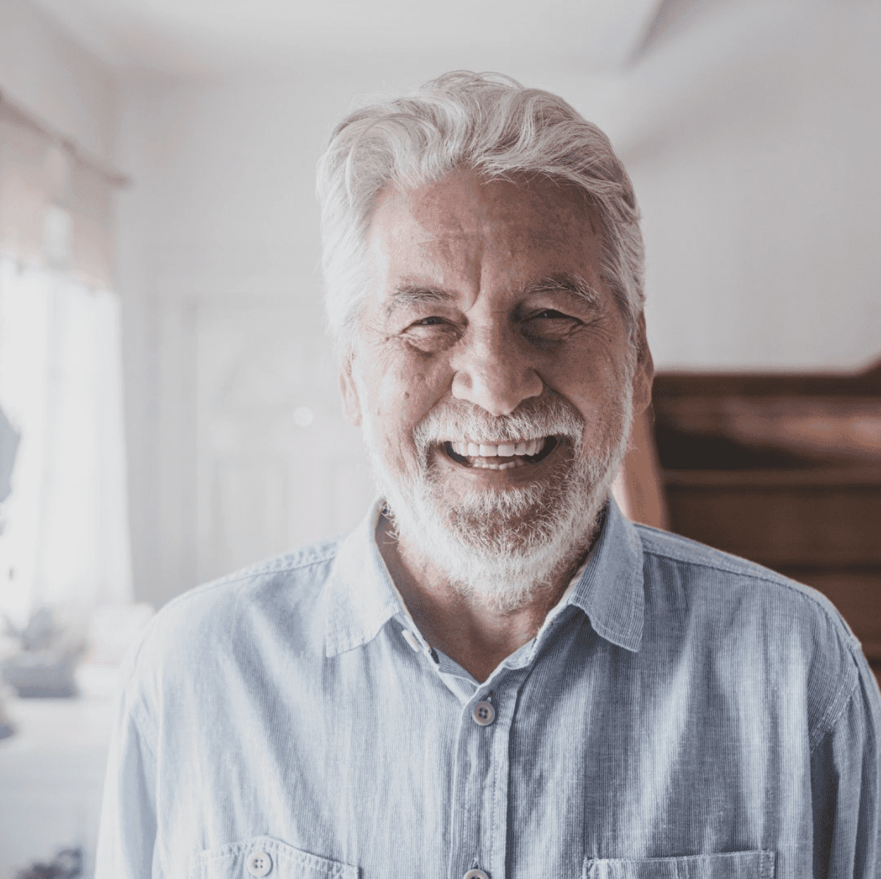 Elderly man smiling after dental crown procedure