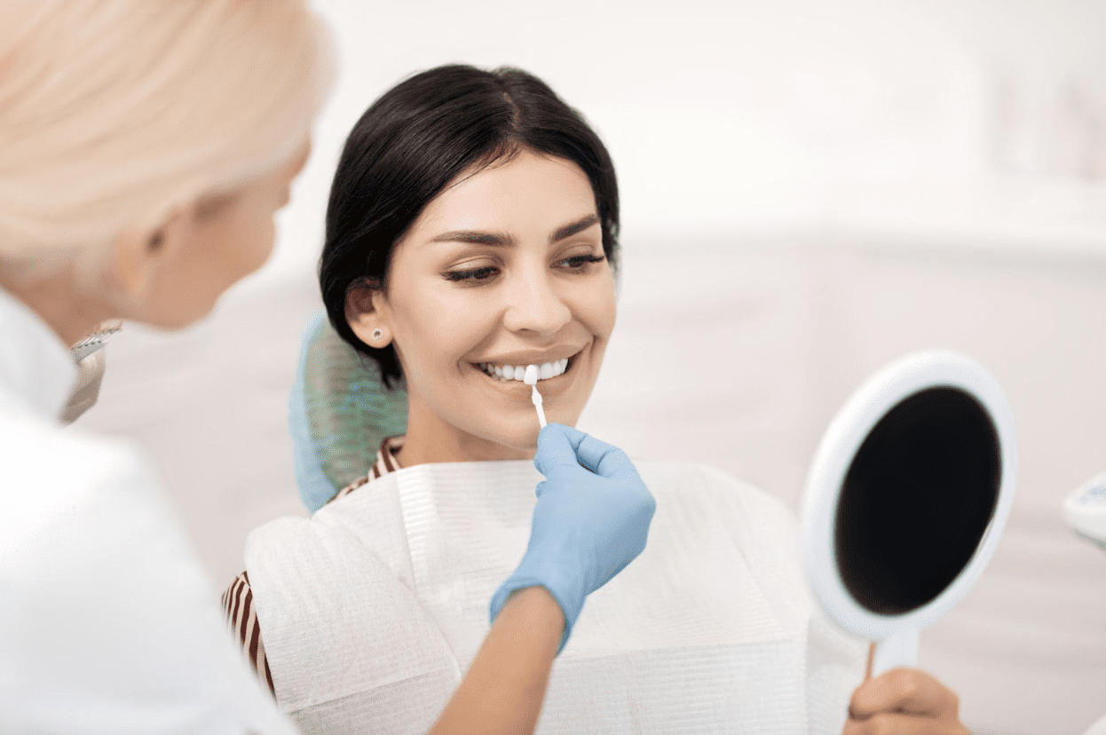 patient looking at teeth color at the dentist