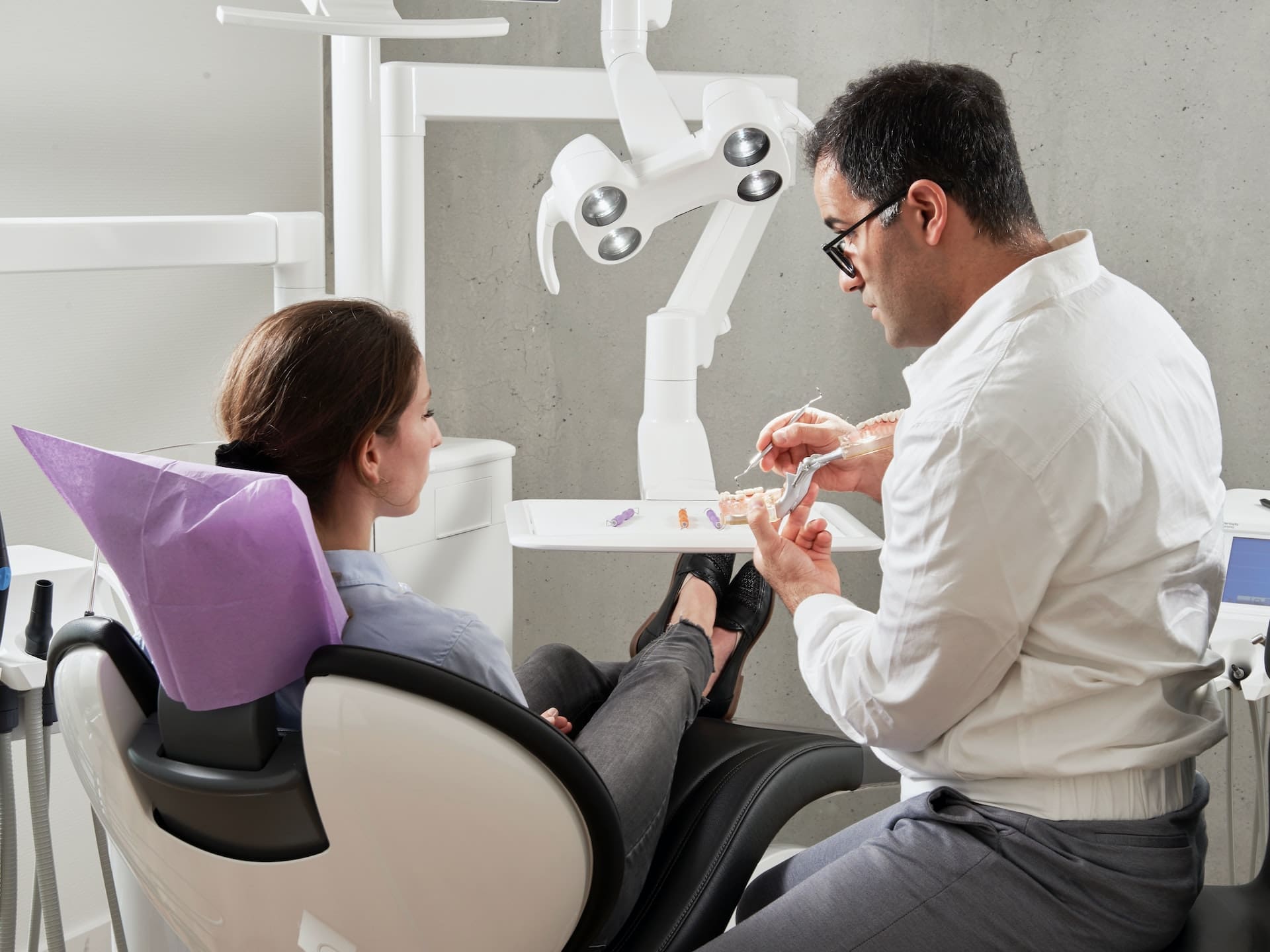 Dentist explaining dental bridges treatment to patient