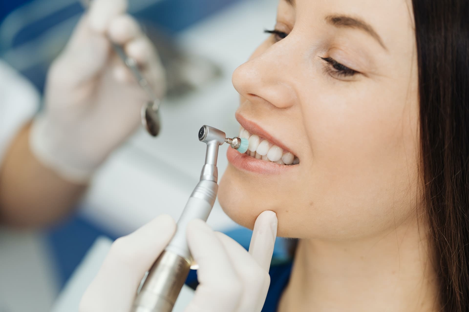 Woman receiving teeth whitening treatment