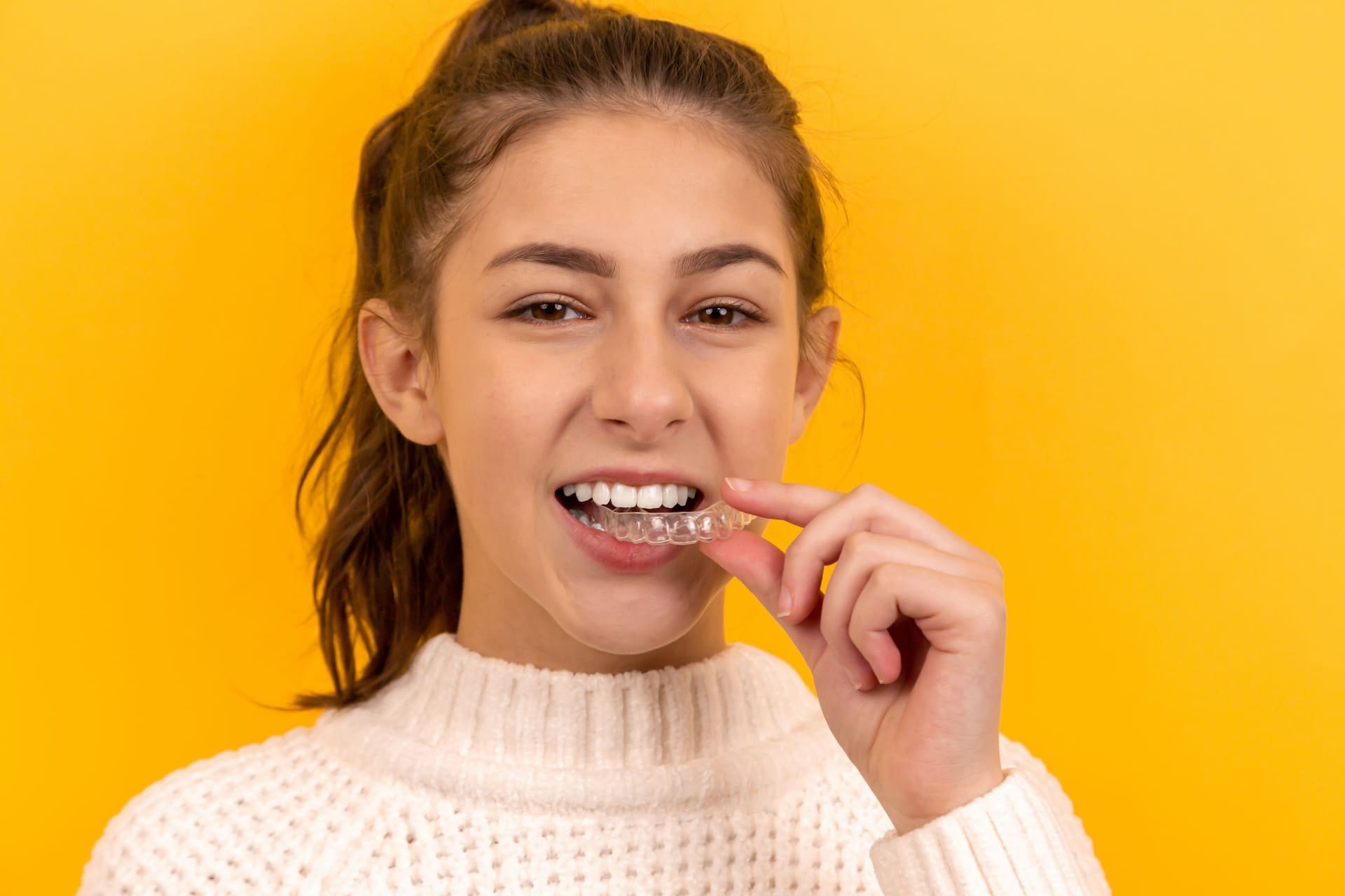 Girl wearing Invisalign aligners