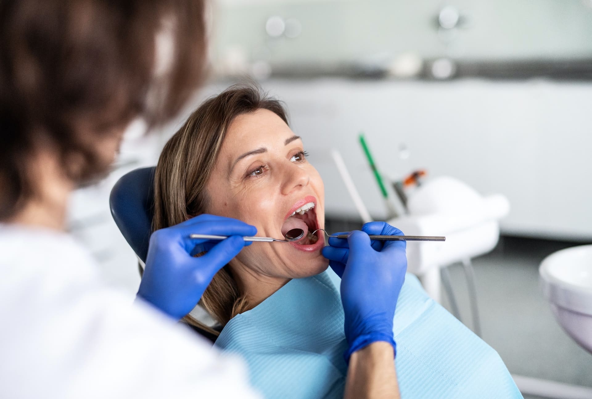 Patient receiving routine dental examination and cleaning